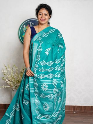 Turquoise Saree with White Floral Motifs and Geometric Border