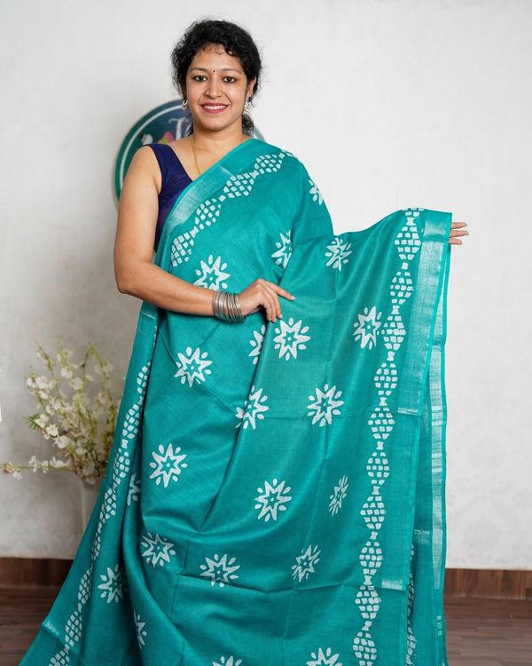 Turquoise Saree with White Floral Motifs and Geometric Border