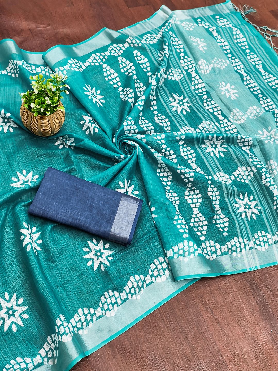 Turquoise Saree with White Floral Motifs and Geometric Border